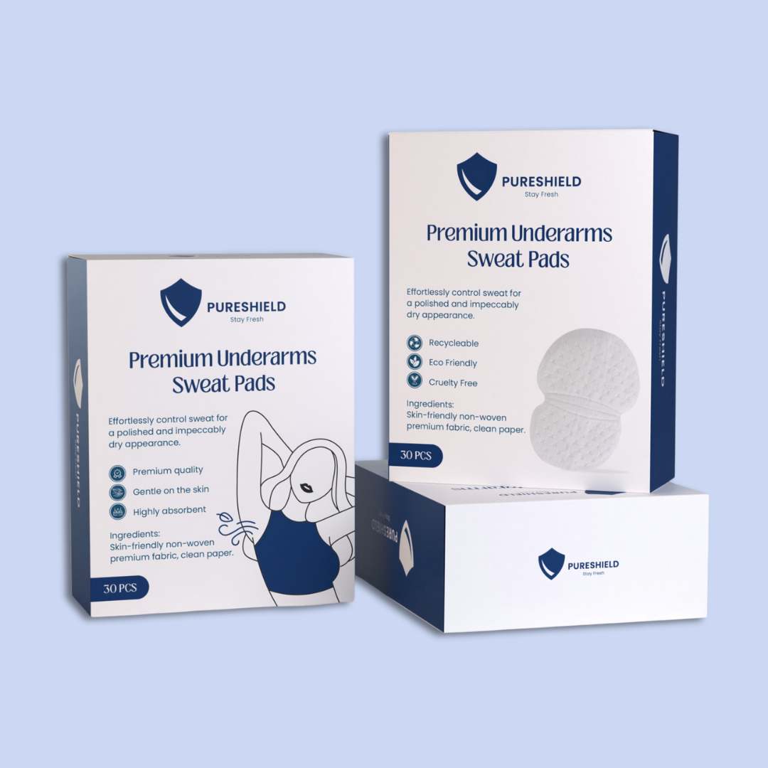 Two boxes of Pureshield Premium Underarms Sweat Pads on a light blue background