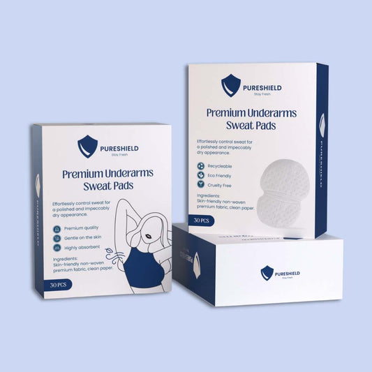 Two boxes of Pureshield Premium Underarms Sweat Pads on a light blue background